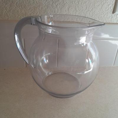 Water pitcher with four glasses and four Rubbermaid plastic plates