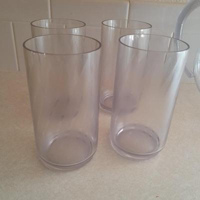 Water pitcher with four glasses and four Rubbermaid plastic plates