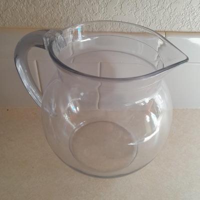 Water pitcher with four glasses and four Rubbermaid plastic plates