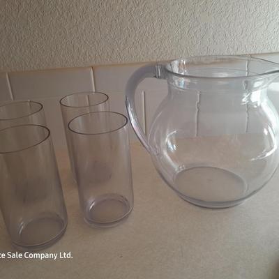 Water pitcher with four glasses and four Rubbermaid plastic plates