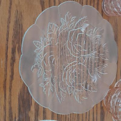 Pink depression glass with two divided pressed glass dishes and a rose patterned dish