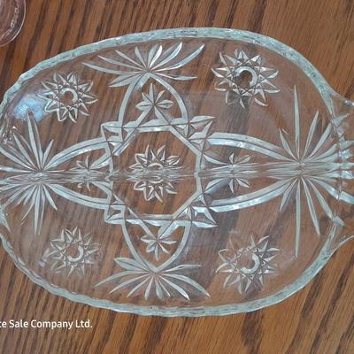 Pink depression glass with two divided pressed glass dishes and a rose patterned dish