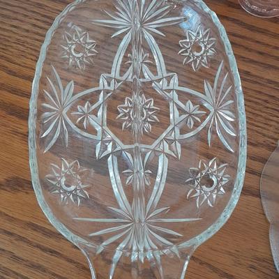 Pink depression glass with two divided pressed glass dishes and a rose patterned dish