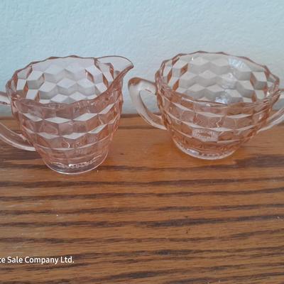 Pink depression glass with two divided pressed glass dishes and a rose patterned dish