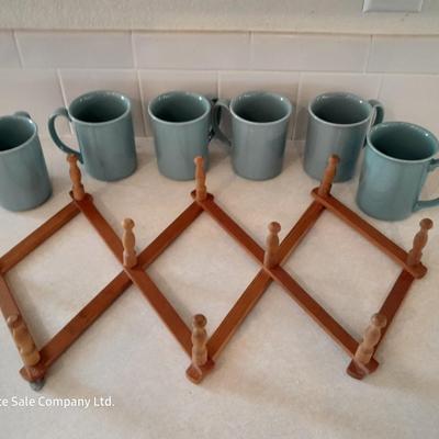 Six matching Corning Mugs with wooden wall hung mug holder.