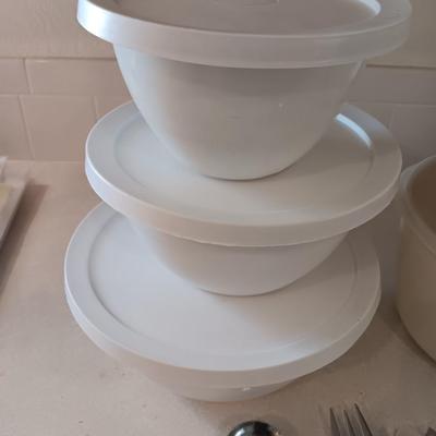 Two sets of plastic food storage containers - nesting - with lids - and serving utensils