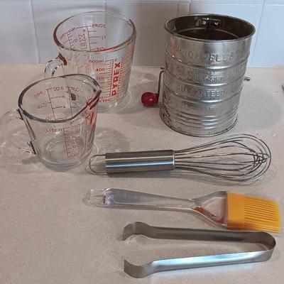 Two glass measuring cups - kitchen utensils - flour sifter