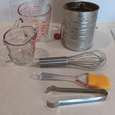 Two glass measuring cups - kitchen utensils - flour sifter