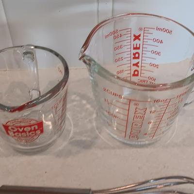 Two glass measuring cups - kitchen utensils - flour sifter