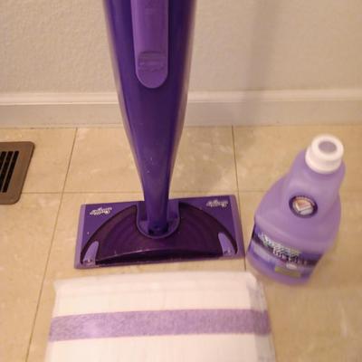 Swiffer wet jet mop with partial bottle of cleaner and few disposable mop pads
