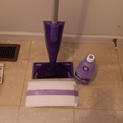 Swiffer wet jet mop with partial bottle of cleaner and few disposable mop pads