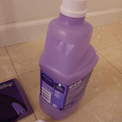 Swiffer wet jet mop with partial bottle of cleaner and few disposable mop pads