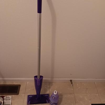 Swiffer wet jet mop with partial bottle of cleaner and few disposable mop pads
