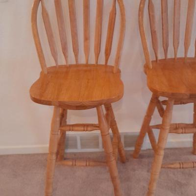 Two nice oak high back swivel bar stools