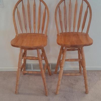 Two nice oak high back swivel bar stools