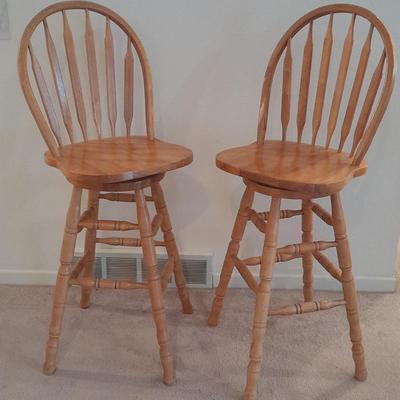 Two nice oak high back swivel bar stools