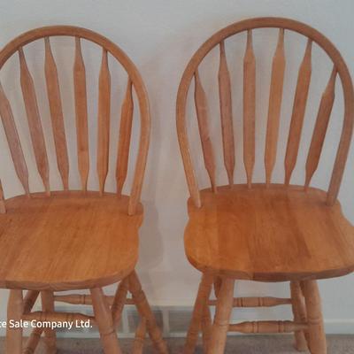 Two nice oak high back swivel bar stools
