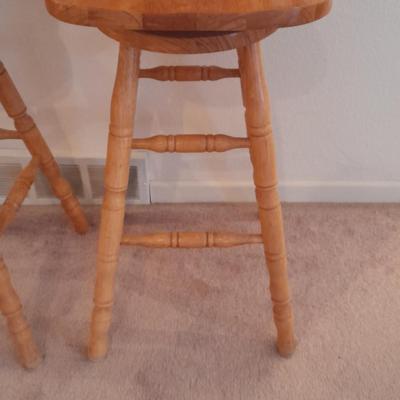 Two nice oak high back swivel bar stools