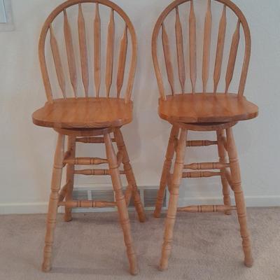 Two nice oak high back swivel bar stools