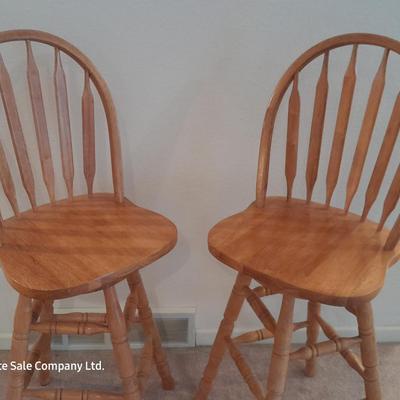 Two nice oak high back swivel bar stools
