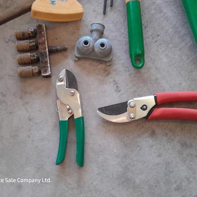 Variety of Garden hand tools - Clippers - lopers - saw - sprinkler heads and more