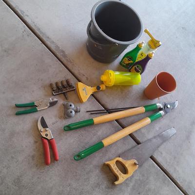 Variety of Garden hand tools - Clippers - lopers - saw - sprinkler heads and more