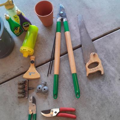 Variety of Garden hand tools - Clippers - lopers - saw - sprinkler heads and more