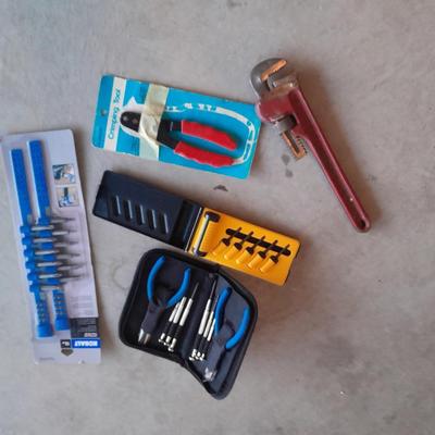Variety of tools - pipe wrench - drill bits - pliers set in storage bag and more