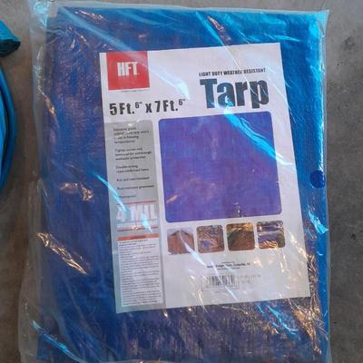 Two blue extension cords and a brand new 5x7 tarp