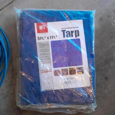 Two blue extension cords and a brand new 5x7 tarp