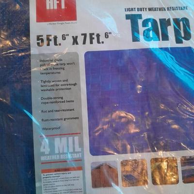 Two blue extension cords and a brand new 5x7 tarp
