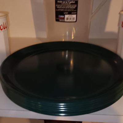 Plastic pitcher with six plastic Coors cups and green plastic plates