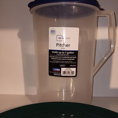 Plastic pitcher with six plastic Coors cups and green plastic plates