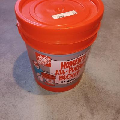 Snow shovel with about half a bucket of salt