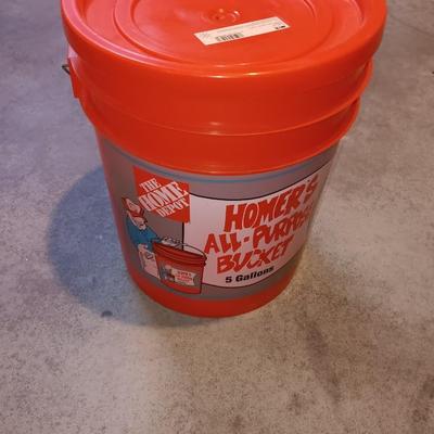 Snow shovel with about half a bucket of salt