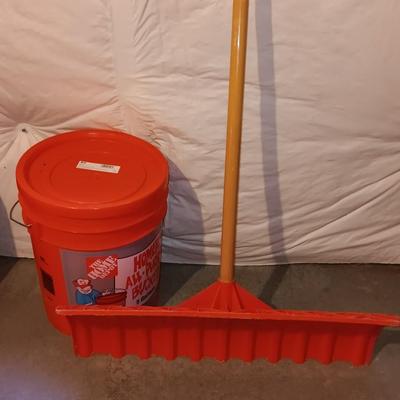 Snow shovel with about half a bucket of salt