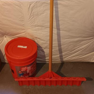 Snow shovel with about half a bucket of salt