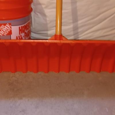 Snow shovel with about half a bucket of salt