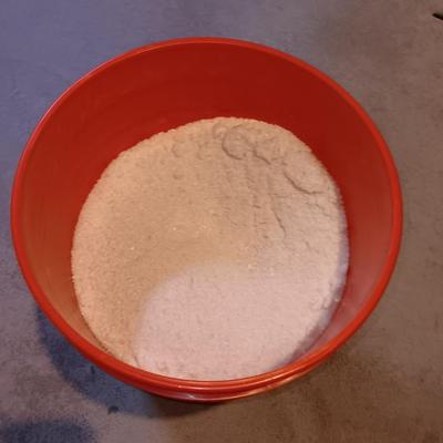 Snow shovel with about half a bucket of salt