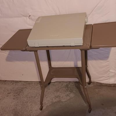 Smith Corona XL1500 electric typewriter on vintage metal typewriter stand.