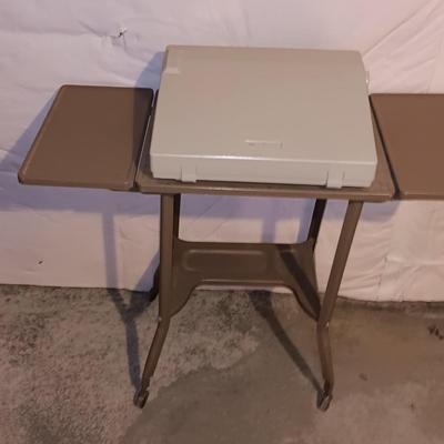 Smith Corona XL1500 electric typewriter on vintage metal typewriter stand.