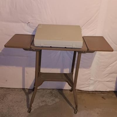 Smith Corona XL1500 electric typewriter on vintage metal typewriter stand.
