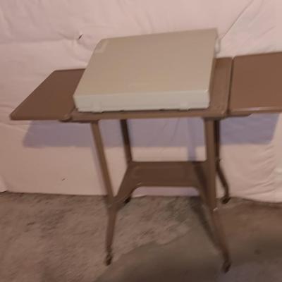 Smith Corona XL1500 electric typewriter on vintage metal typewriter stand.