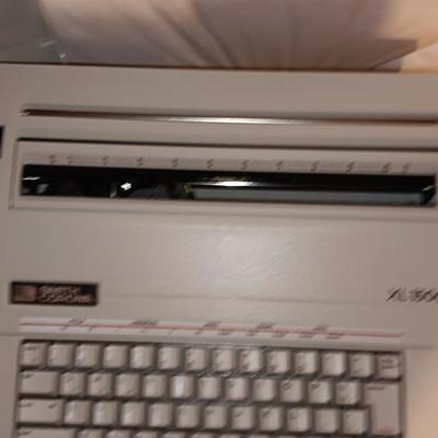 Smith Corona XL1500 electric typewriter on vintage metal typewriter stand.