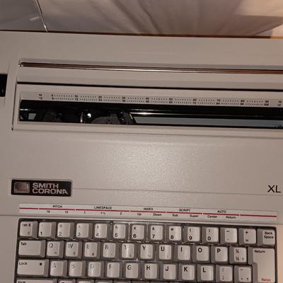 Smith Corona XL1500 electric typewriter on vintage metal typewriter stand.