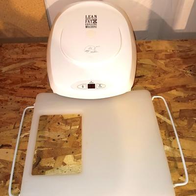 George Foreman Lean mean fat grilling machine with cutting board for over the disposal.