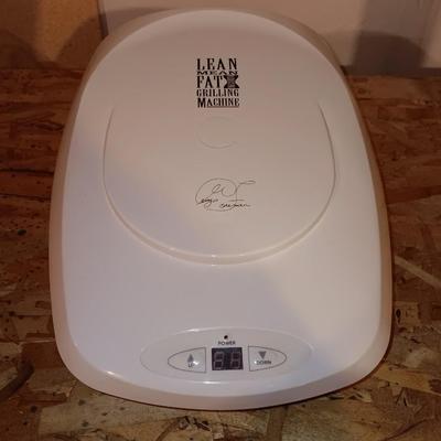 George Foreman Lean mean fat grilling machine with cutting board for over the disposal.