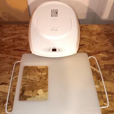 George Foreman Lean mean fat grilling machine with cutting board for over the disposal.