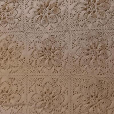 Hand knitted bed spread. square floral pattern