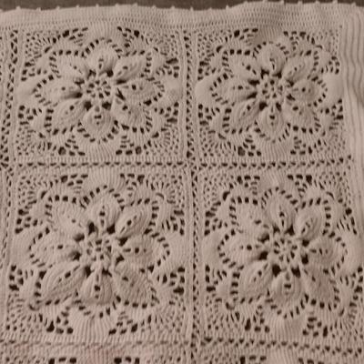Hand knitted bed spread. square floral pattern